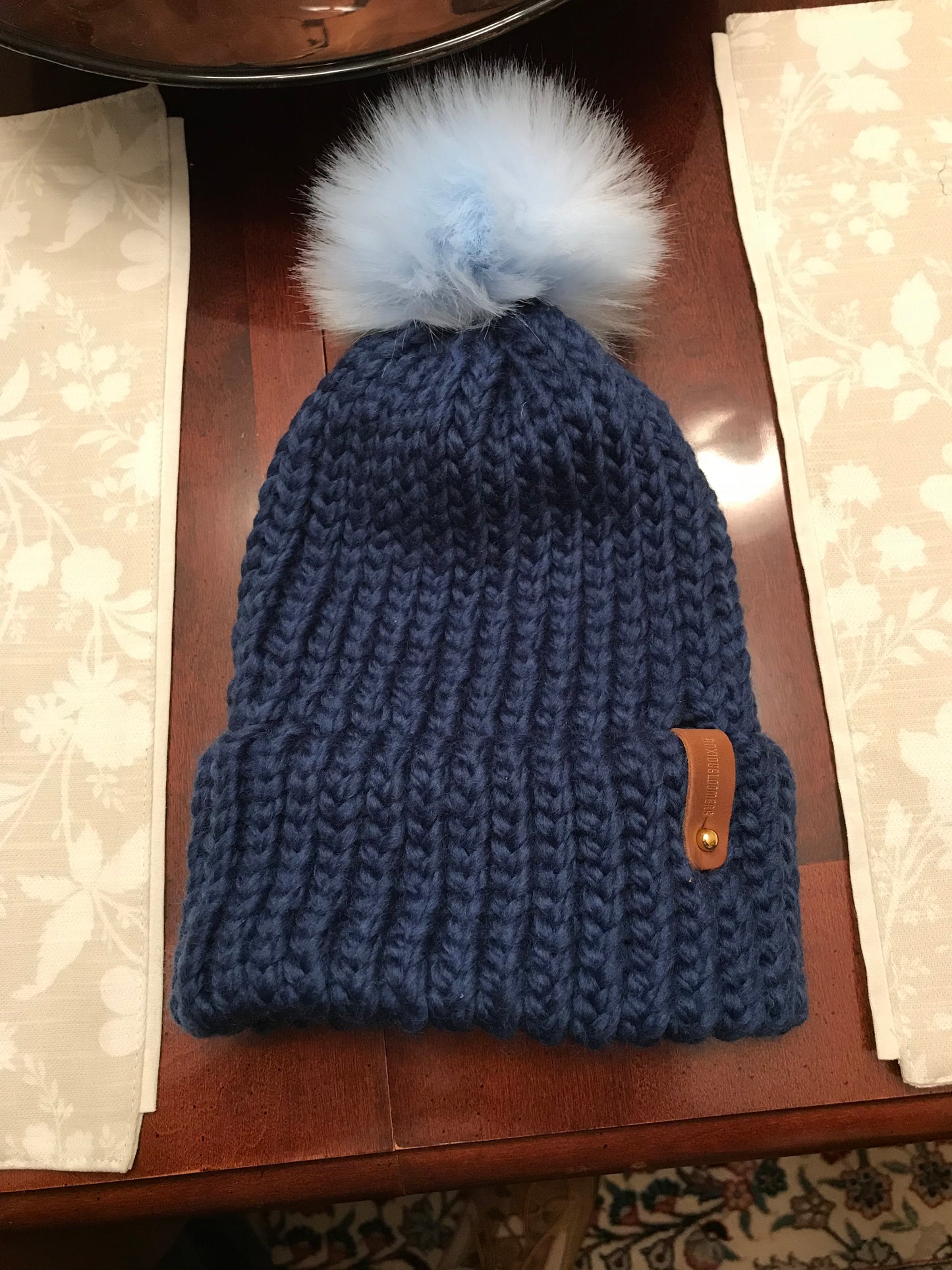 BLUE BABY HAT, BLUE POMOPOM WITH ANXIOULSOOMERS TAG
