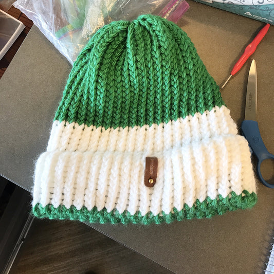 GREEN AND WHITE HAT WITH ANXIOUSLOOMERS TAG