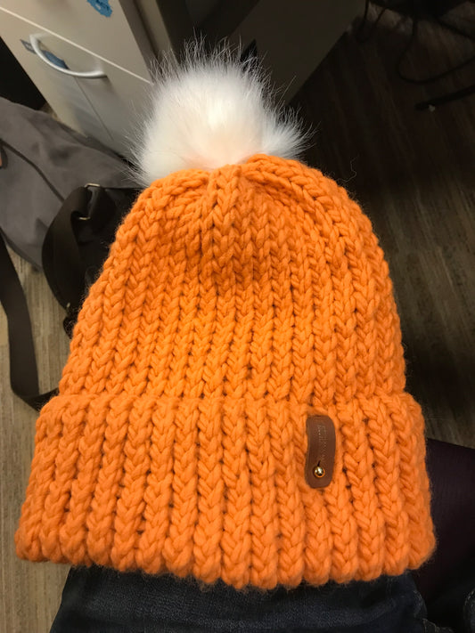 ORANGE HAT, WHITE POMPOM WITH ANXIOUSLOOMERS TAG