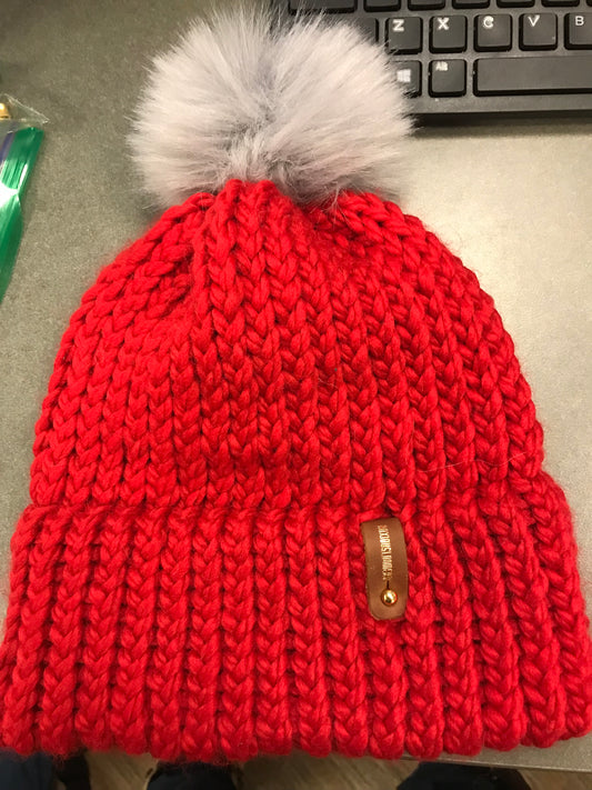 RED HAT WITH GREY POMPOM WITH ANXIOUSLOOMERS TAG
